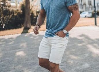 sexy guy dressed in shorts and a blue collared shirt for a summer first date